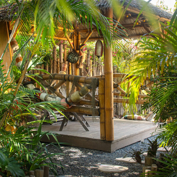 Palapa with thatch roof and bamboo accents at Tropic Shots production set