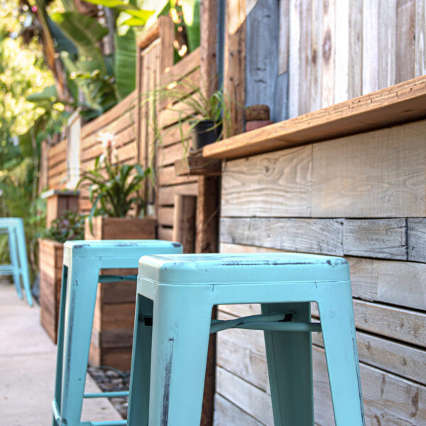 Wood wall close-up accents with barstools at Tropic Shots production set